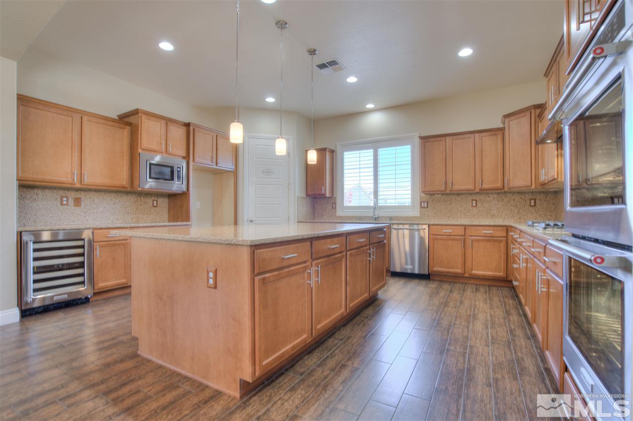 9800 Shadowless Trail Reno, NV 89521 - Photo 13 of 36 a kitchen with stainless steel appliances sink refrigerator and microwave