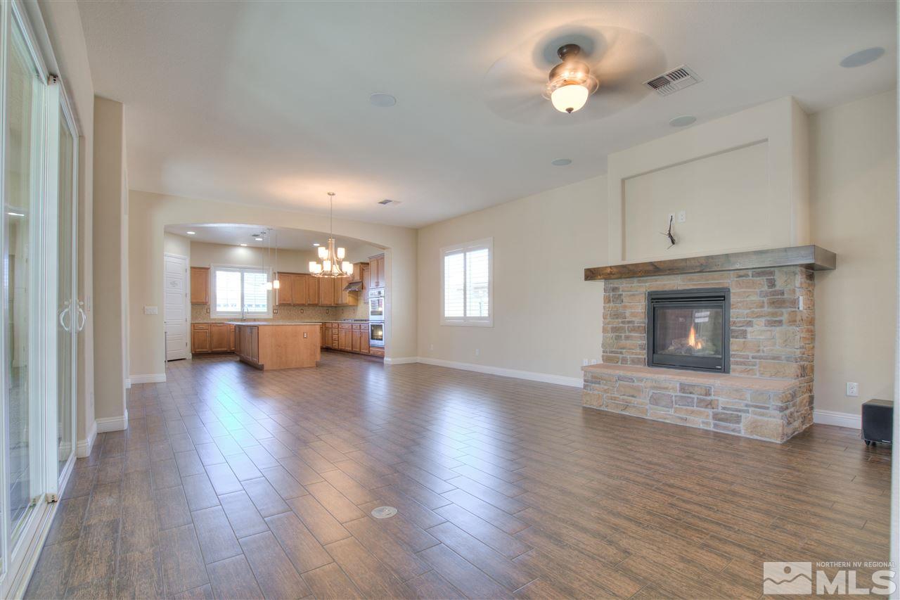 9800 Shadowless Trail Reno, NV 89521 - Photo 10 of 36 a view of a livingroom with a fireplace a fireplace and windows