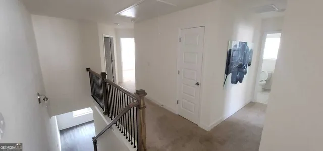 a view of a hallway with windows and stairs