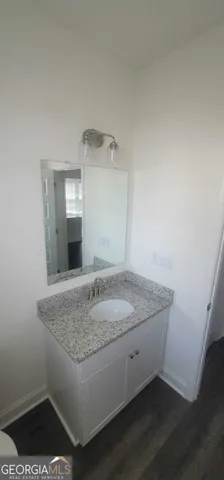 a bathroom with a granite countertop sink and vanity