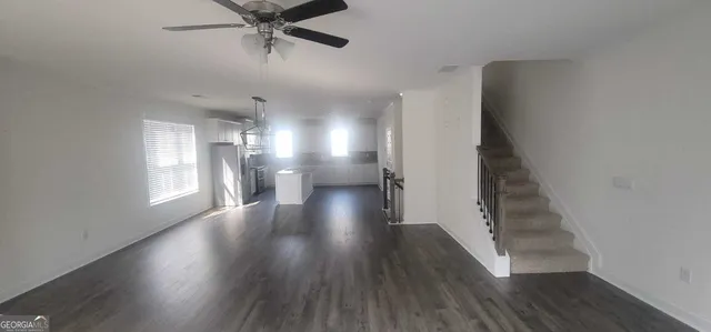 a view of entryway and hall with wooden floor