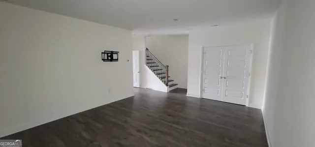a view of an entryway with wooden floor