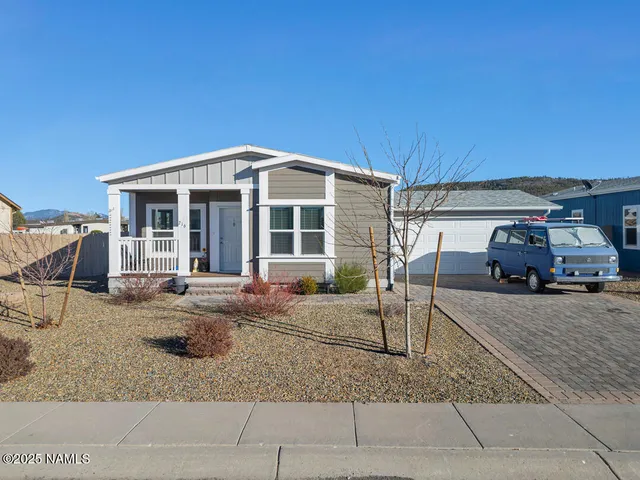 a front view of a house with backyard porch and sitting area