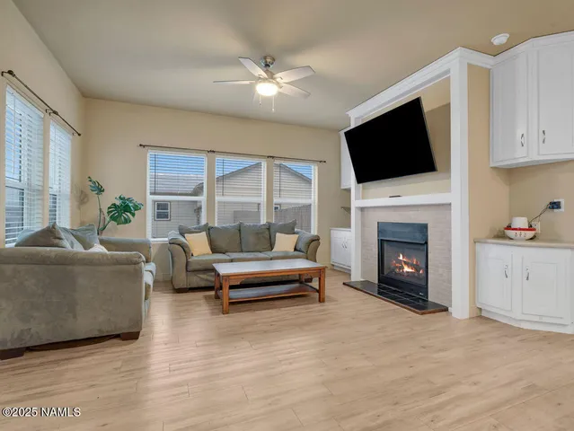 a living room with furniture fireplace and flat screen tv