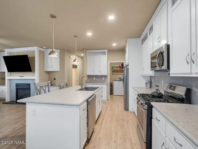 a kitchen with a sink stove and microwave