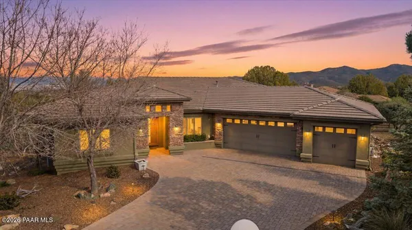 a front view of a building with a yard