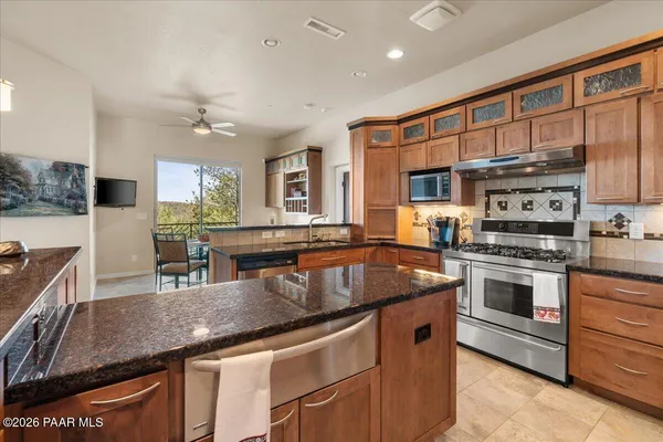 a kitchen with stainless steel appliances granite countertop a stove and a sink