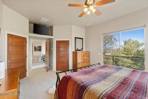 a bedroom with a bed dresser and a window