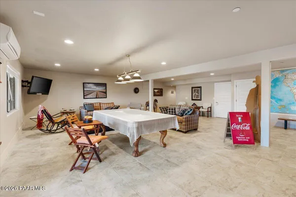 a living room with lots of furniture and a flat screen tv
