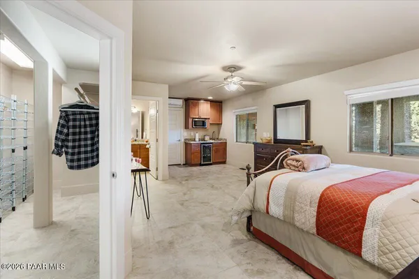 a bed room with a bed and a view of kitchen