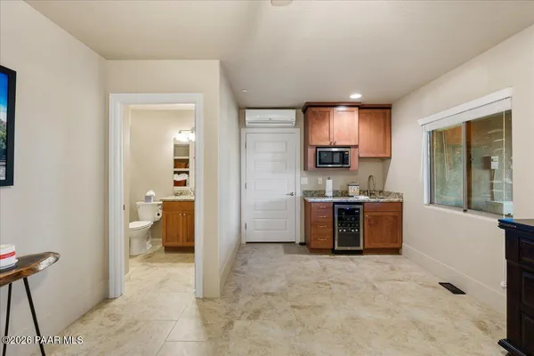a view of a open shower and a kitchen