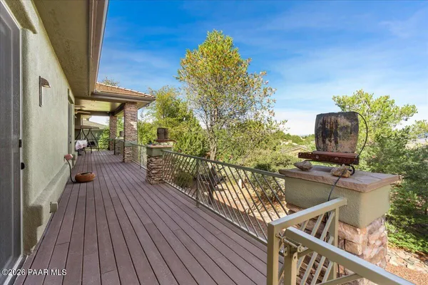 a view of a balcony with wooden floor and outdoor seating