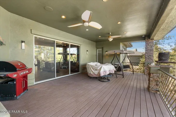 a living room with furniture a wooden floor and next to a window