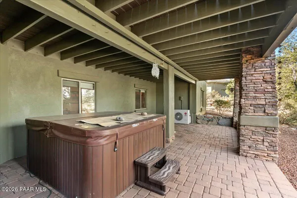 a dinning table and chairs in porch of a room