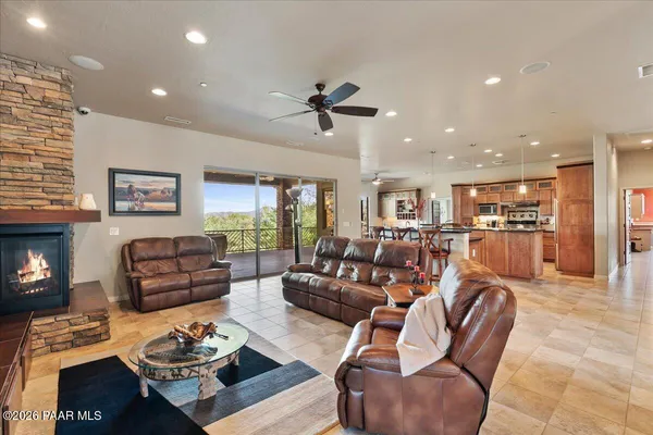 a living room with furniture kitchen view and a fireplace