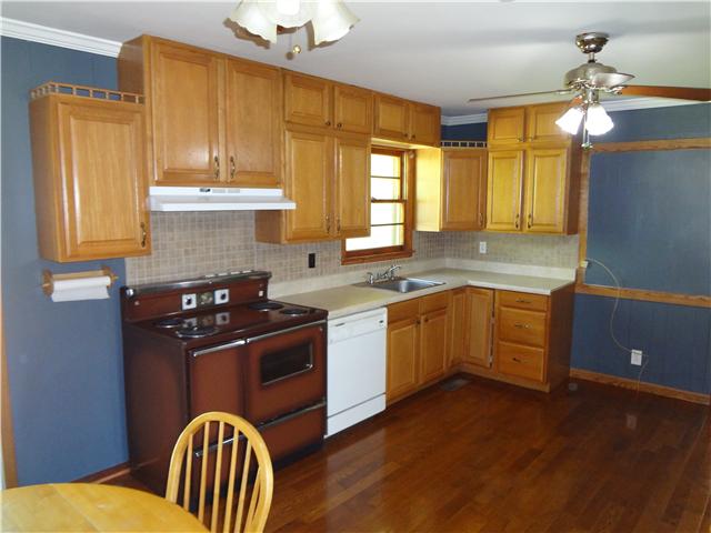 1329 Oak Grove Road Goodspring, TN 38460 - Photo 6 of 20 a kitchen with stainless steel appliances granite countertop a sink a stove cabinets counter space and a window