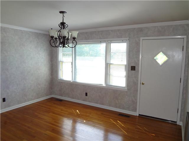 1329 Oak Grove Road Goodspring, TN 38460 - Photo 9 of 20 an empty room with wooden floor and windows