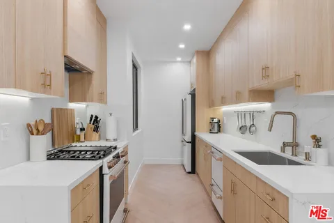 a kitchen with a sink stove and refrigerator