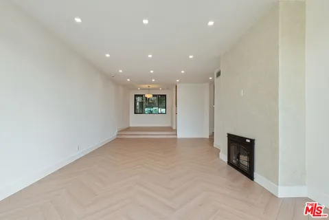 a view of an empty room with a fireplace