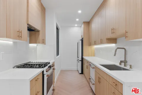 a kitchen with a sink stove and refrigerator