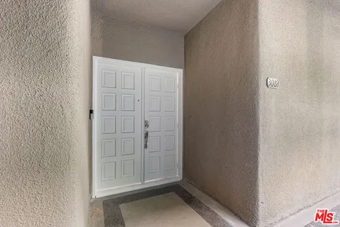 a view of an empty room with a floor to ceiling window