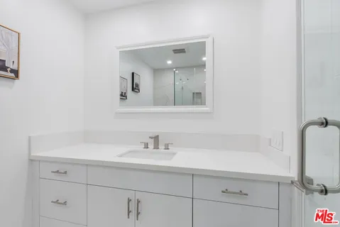 a bathroom with a tub sink and mirror