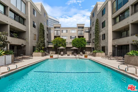 a view of a house with swimming pool and sitting area