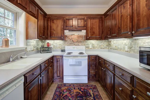 a kitchen with a sink stove and cabinets