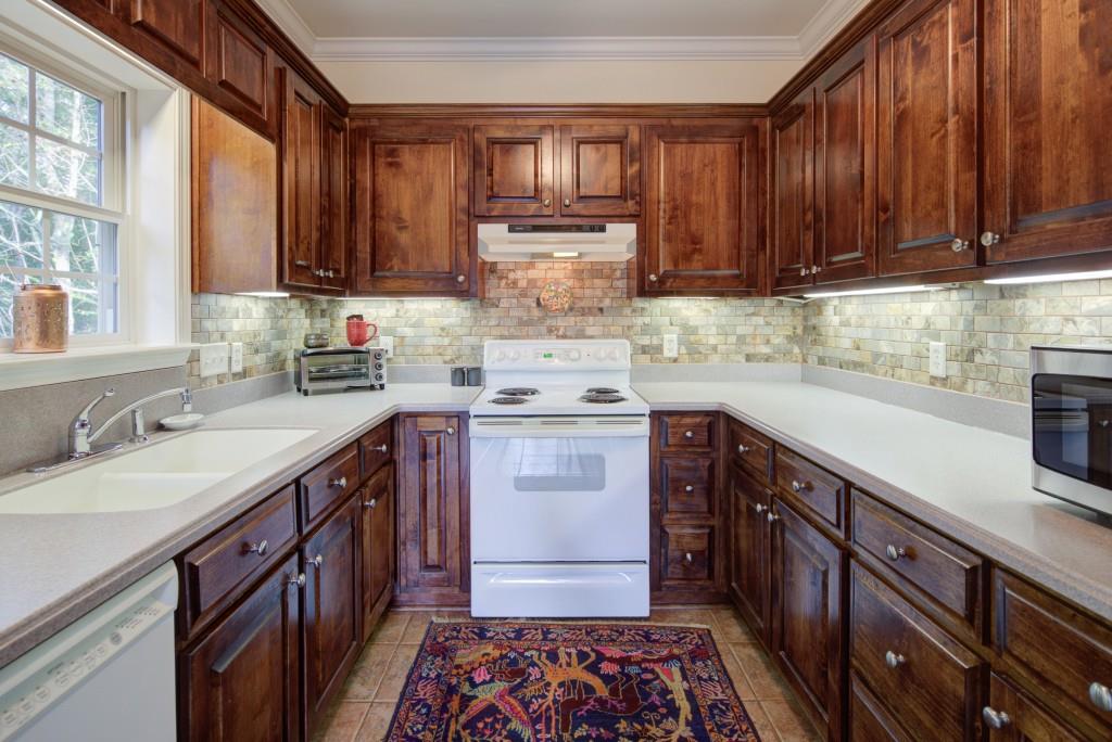 1170 Calhoun Road Dahlonega, GA 30533 - Photo 11 of 34 a kitchen with a sink stove and cabinets