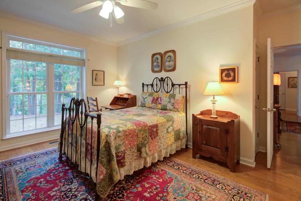 1170 Calhoun Road Dahlonega, GA 30533 - Photo 16 of 34 a bed room with a bed and a chandelier