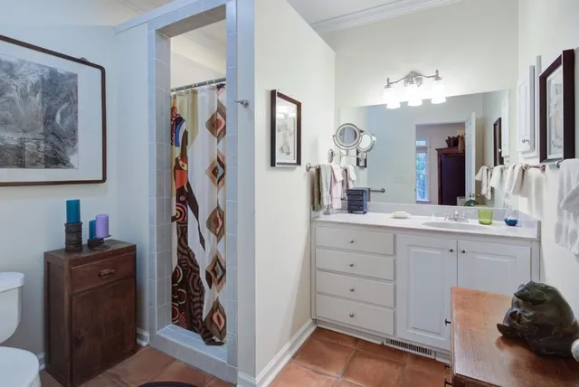 a bathroom with a sink vanity and a mirror