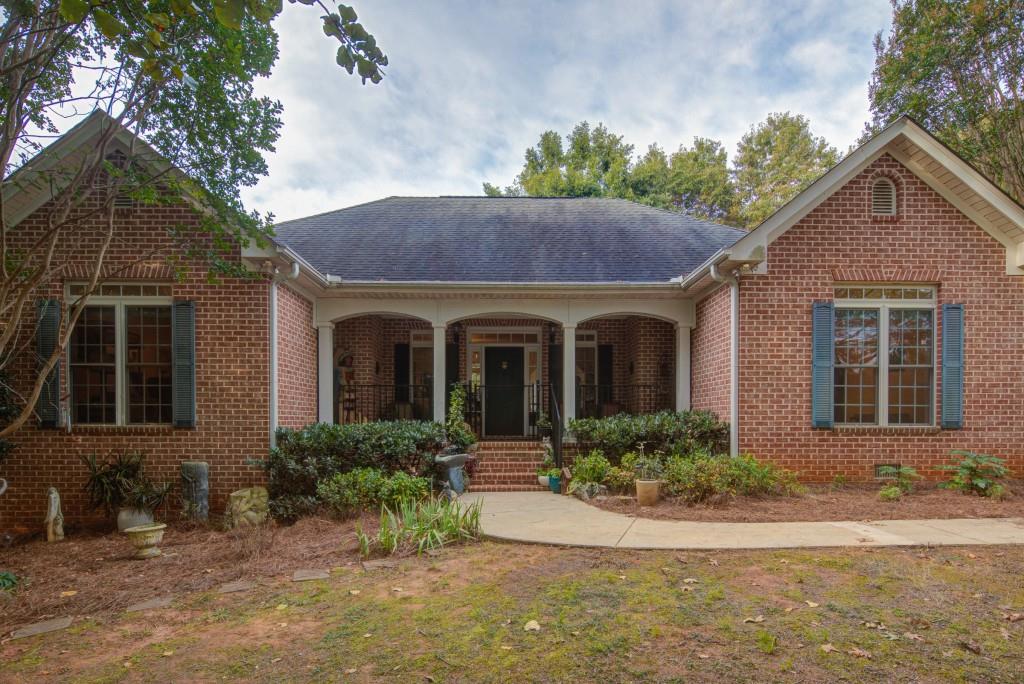 1170 Calhoun Road Dahlonega, GA 30533 - Photo 24 of 34 a front view of a house with garden