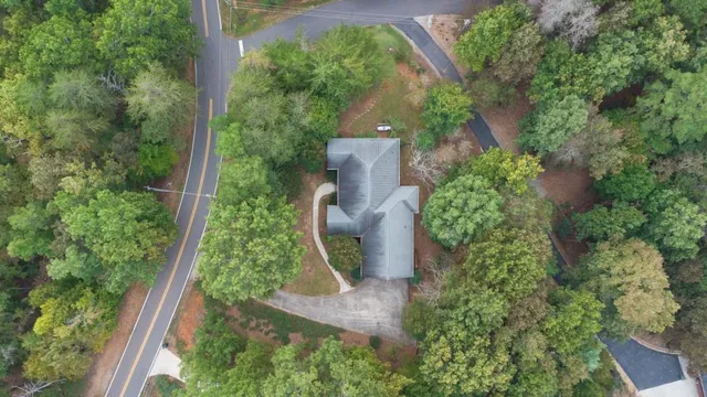 an aerial view of a house with a yard and garden