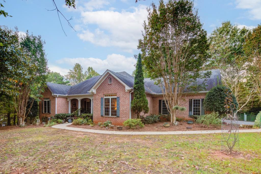 1170 Calhoun Road Dahlonega, GA 30533 - Photo 34 of 34 a front view of a house with a garden and trees