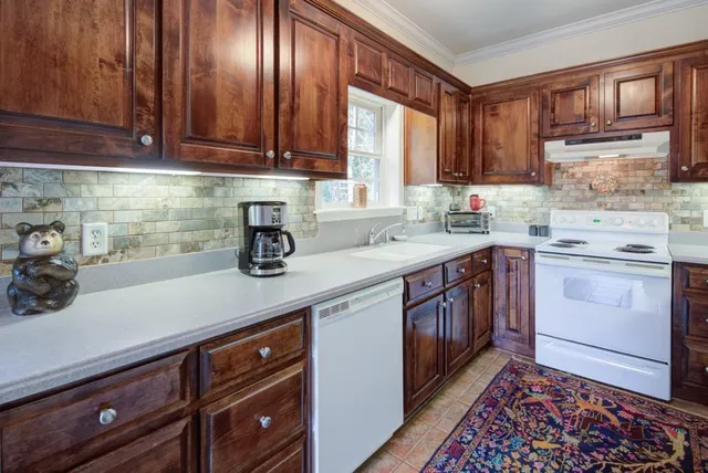 a kitchen with a sink stove and cabinets