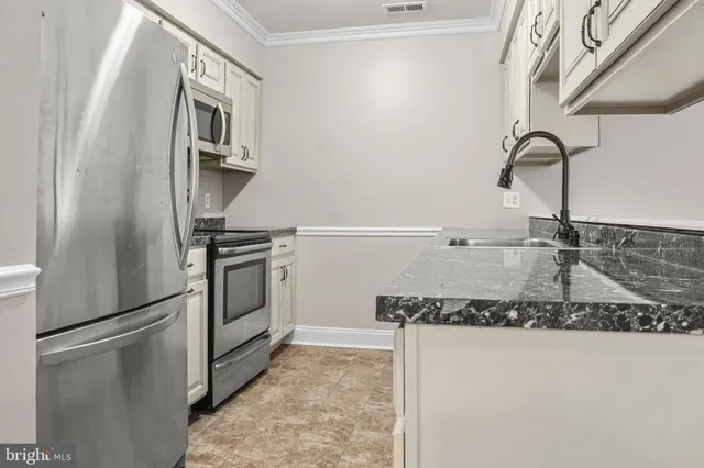 a kitchen with a refrigerator and a sink