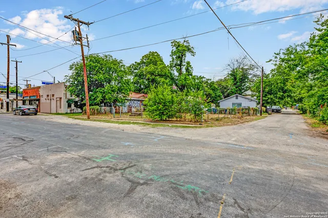 a view of a street with potted plants