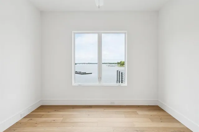 a view of a small space with wooden floor and a window
