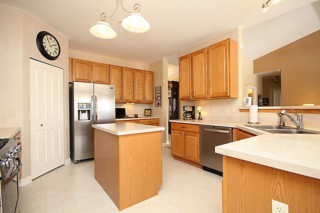 901 Price Road Sugar Grove, IL 60554 - Photo 8 of 25 a kitchen with a refrigerator a sink a stove and cabinets