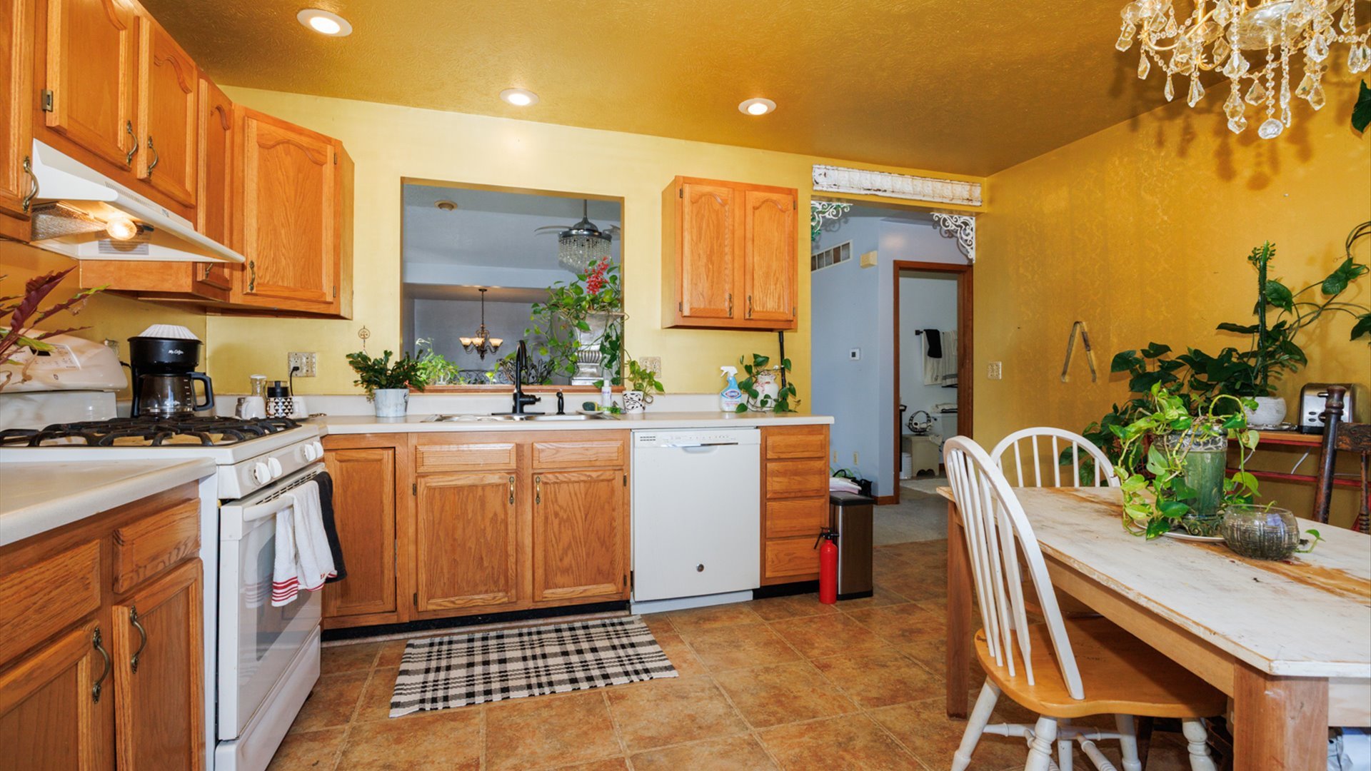 67 Oak Park Road Bloomington, IL 61701 - Photo 11 of 34 a kitchen that has a sink and chair