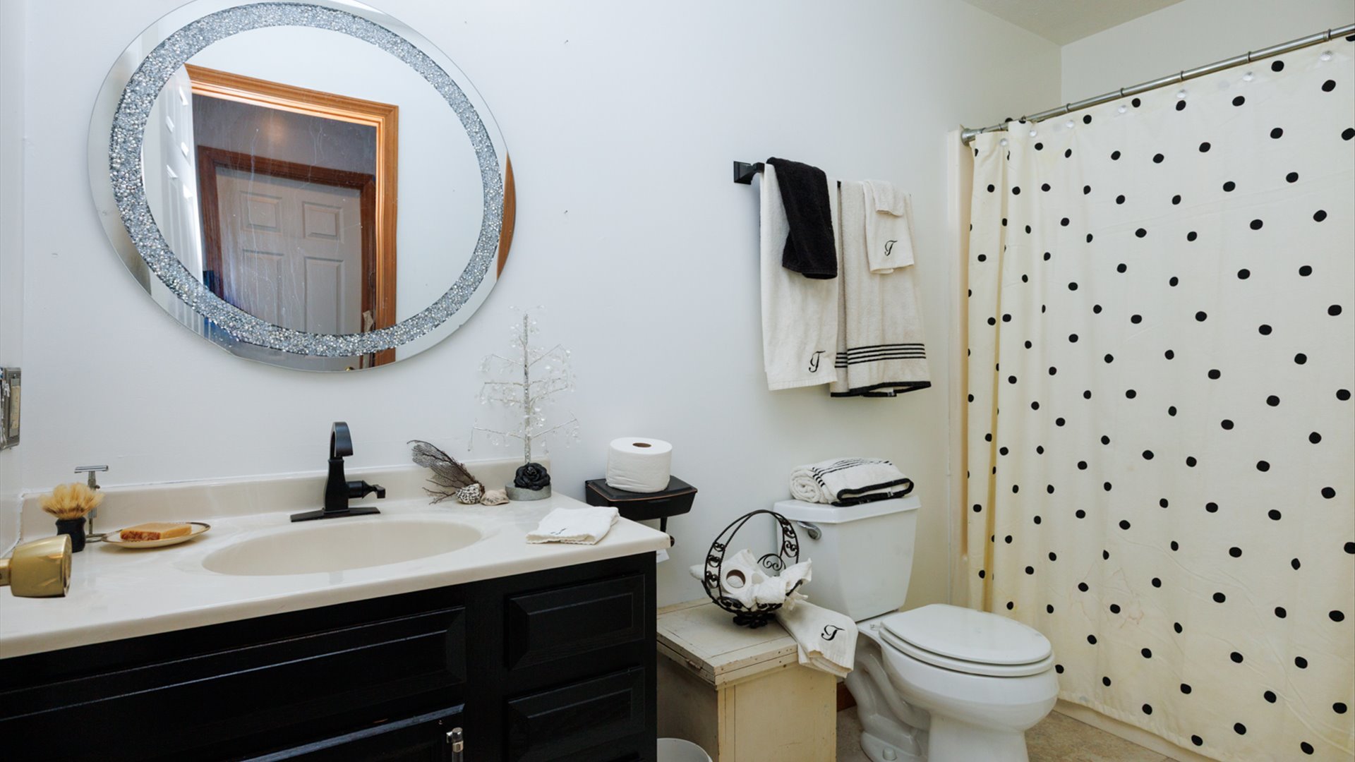 67 Oak Park Road Bloomington, IL 61701 - Photo 20 of 34 a bathroom with a sink a toilet and a mirror