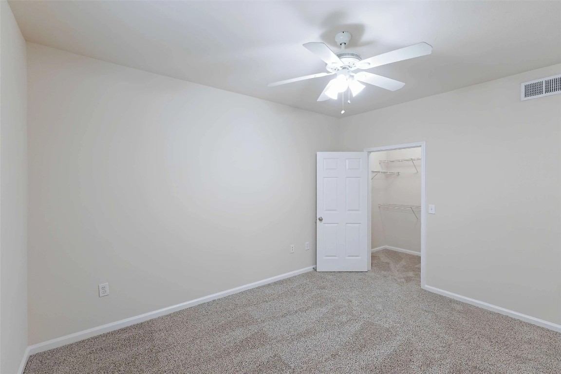 10505 South I-35 Frontage Road, Unit 222 Austin, TX 78747 - Photo 13 of 25 an empty room with a chandelier fan and windows