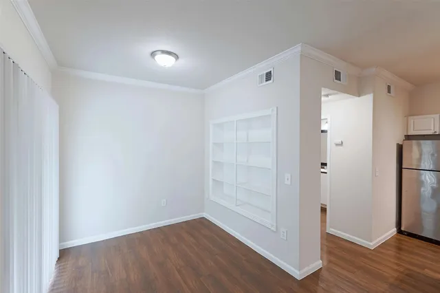 a kitchen with a refrigerator a stove a sink and a hard wood floor