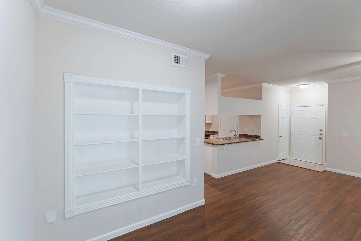 10505 South I-35 Frontage Road, Unit 222 Austin, TX 78747 - Photo 6 of 25 a kitchen with a refrigerator and white cabinets