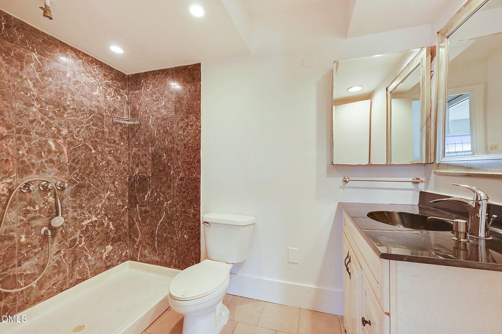 501 Jones Ferry Road, Unit N9 Carrboro, NC 27510 - Photo 11 of 22 a bathroom with a sink a toilet and shower