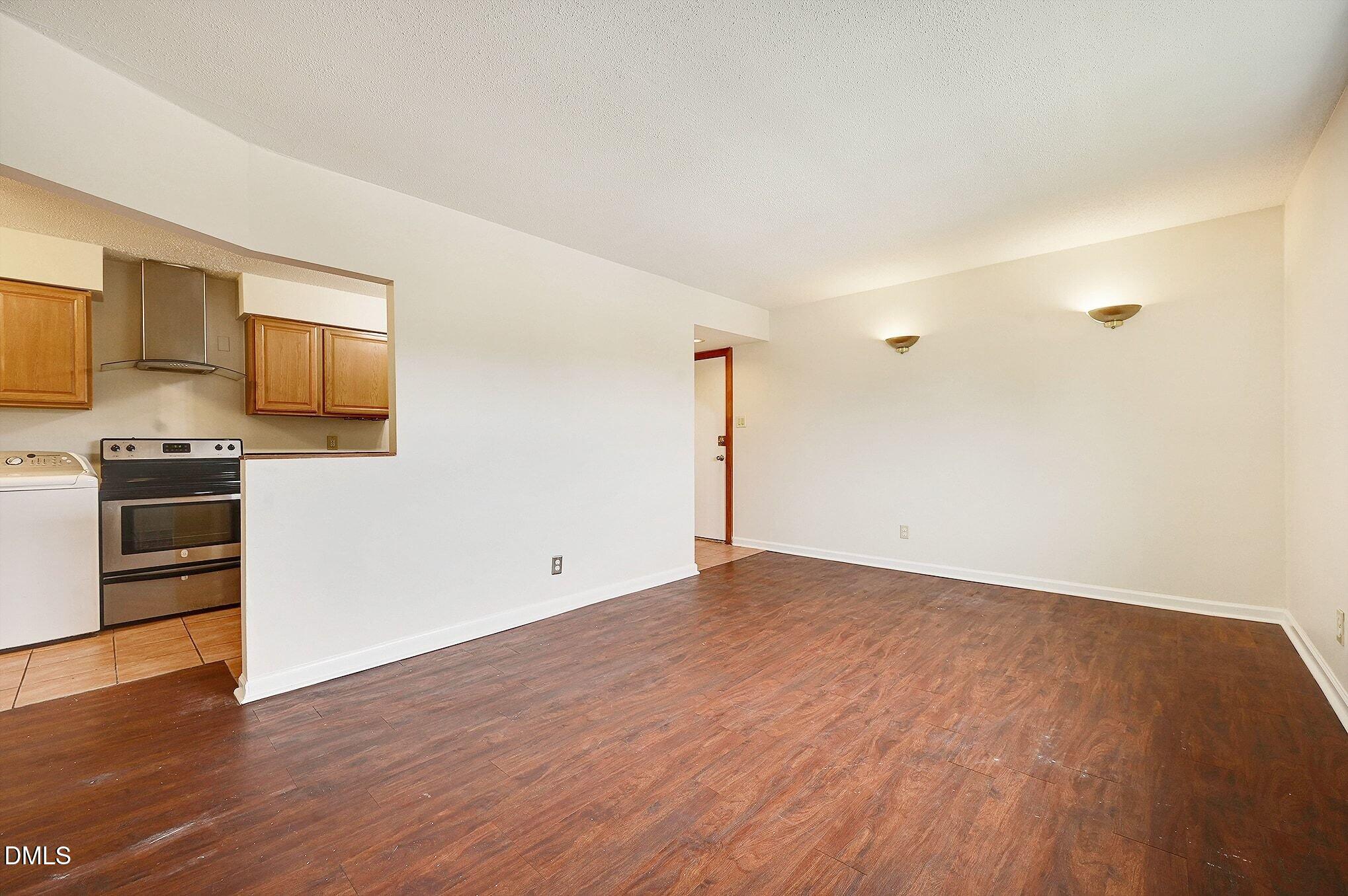 501 Jones Ferry Road, Unit N9 Carrboro, NC 27510 - Photo 4 of 22 a view of empty room with wooden floor and electronic appliances