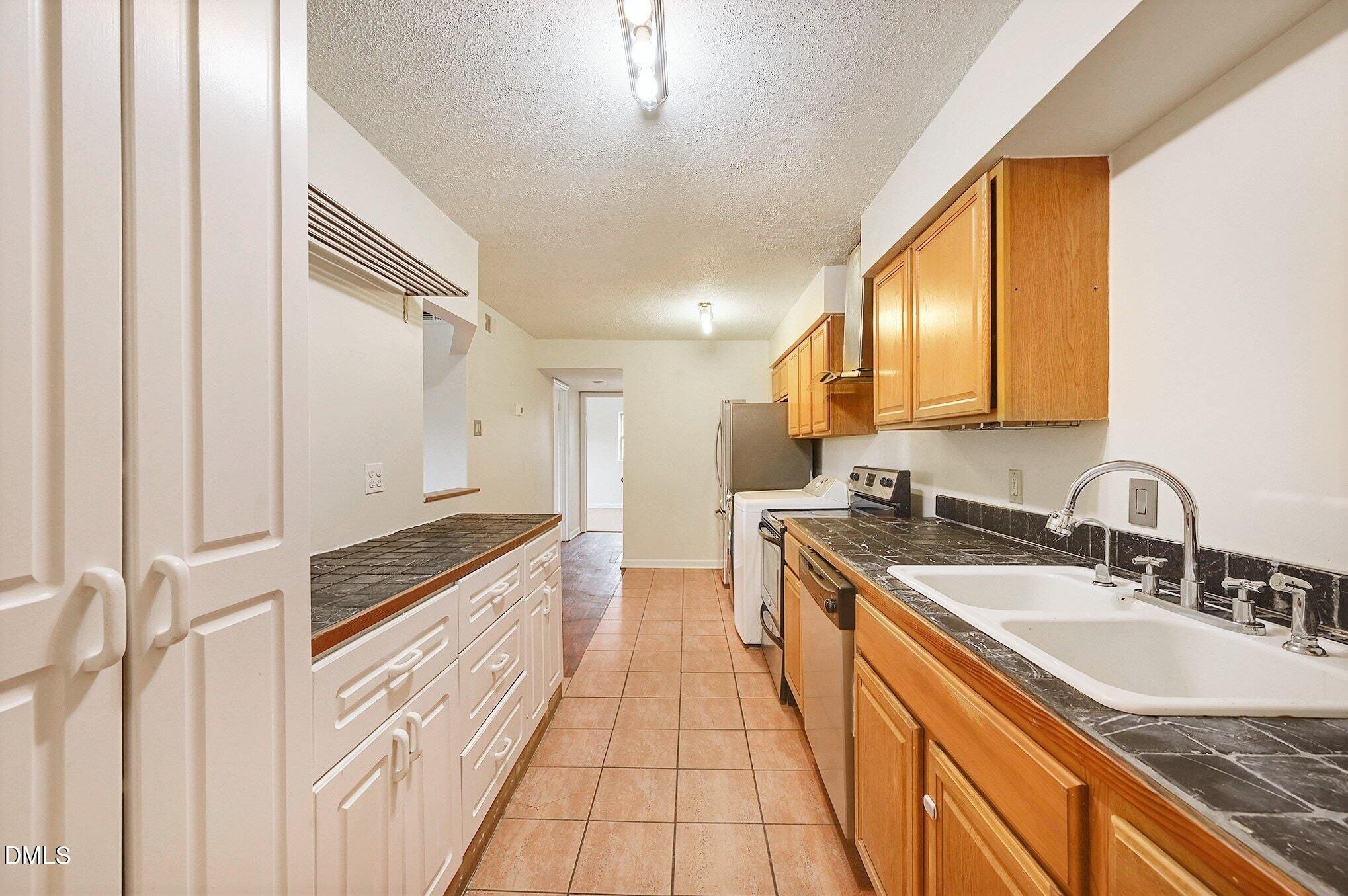 501 Jones Ferry Road, Unit N9 Carrboro, NC 27510 - Photo 6 of 22 a large kitchen with stainless steel appliances granite countertop a sink and cabinets