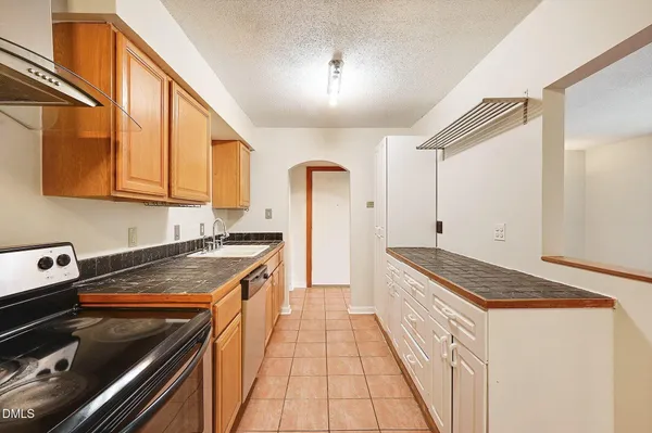 a kitchen with a refrigerator and a stove top oven