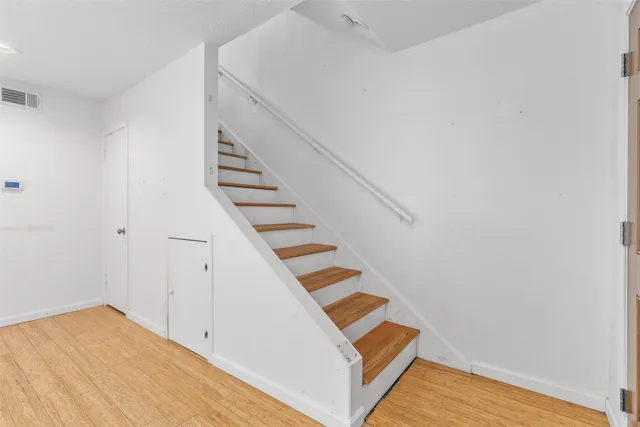a view of an entryway with wooden floor
