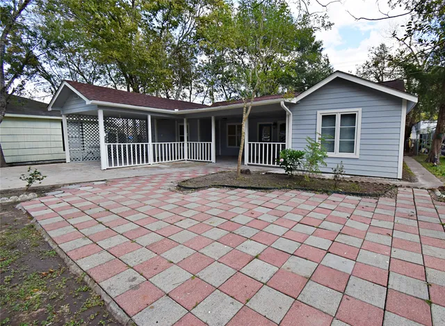 a backyard of a house with yard and outdoor seating